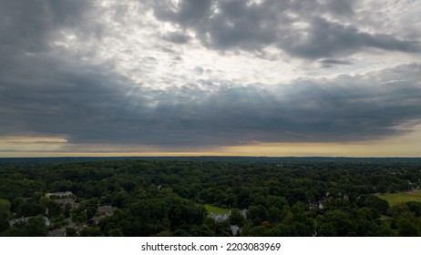 A High Angle, Aerial View Over Glen Cove, NY On A Cloudy Day In The Summer. There Are Lush Green Trees In The Upscale, Residential Neighborhood. Shot Taken By A Drone Camera.