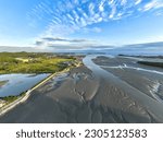 High angle and afternoon view of reclaimed land and mud flat with tidal channel at low tide sea at Seongamdo Island near Ansan-si, Gyeonggi-do, South Korea
