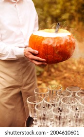 High Angle Of Anonymousmale With Punch Near Pumpkin Bowl During Halloween Celebration