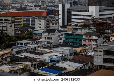 The high angle background of the city view with the secret light of the evening, blurring of night lights, showing the distribution of condominiums, dense homes in the capital community