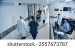 High Angle CCTV Shot with a Busy Hallway with Reception Desk of a Hospital Building, Diverse Female and Male Staff Members Walking, Working. Professional Nurses, Doctors and Personnel at Work