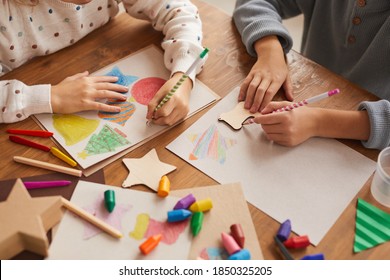 High angle close up of children tracing shapes while drawing Christmas cards in school, copy space