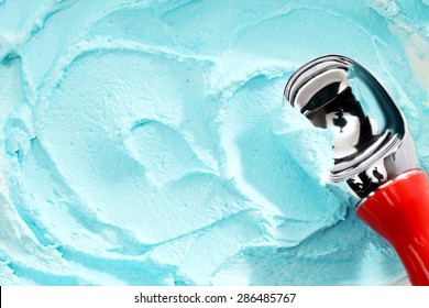 High Angle Close Up View Of Red Handled Scoop Serving Blue Colored Ice Cream