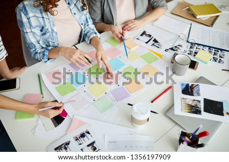 High angle closeup of contemporary business team planning project placing colorful stickers on roadmap, copy space