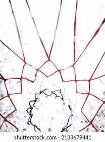 High Angle Closeup View Of Basketball Net Over Snow.Footprints Below, Image Made In Outdoor Basketball Court.