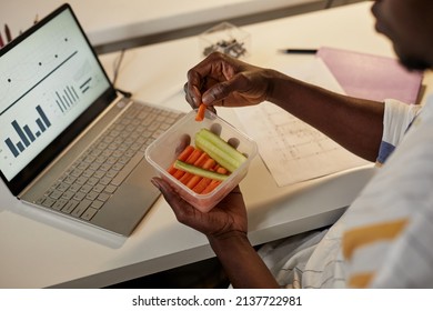 High Angle Closeup Of Young African American Man Eating Healthy Snack While Working Or Studying Late At Night, Copy Space