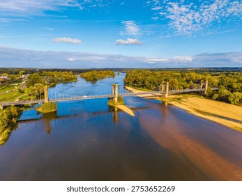 High angle Drone Point of View on the Langeais Bridge, a suspension bridge located in the Indre-et-Loire department and the Centre-Val de Loire region in Western France. The Bridge dates from 1849 and crosses the Loire River between Langeais and La Chapelle-aux-Naux.