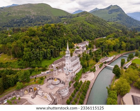 High angle Drone Point of View on the City of Lourdes, Hautes-Pyrenees, Southwestern France on summer day. Lourdes is one of the world's most important sites of pilgrimage and religious tourism. 