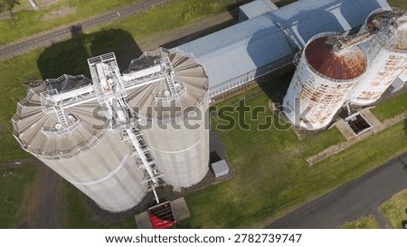 High angle drone shot of large agricultural grain silos and storage buildings in rural Queensland.