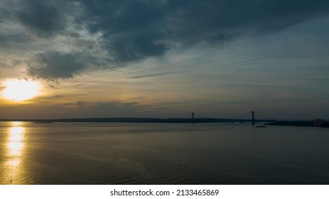 A high angle drone view of Gravesend Bay by Brooklyn, NY. The Verrazano Bridge is in the distance. Taken on a beautiful evening at sunset.