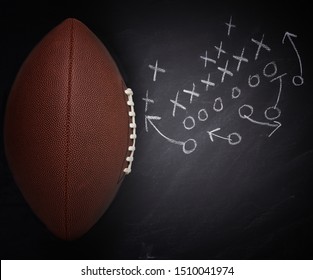 High Angle Flat Lay Of An American Pro Style Football And Play Diagram On A Chalkboard.