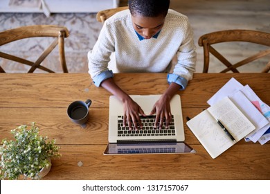 High Angle Of A Focused Young African American Female Entrepreneur Working Online With A Laptop While Sitting At A Table At Home  