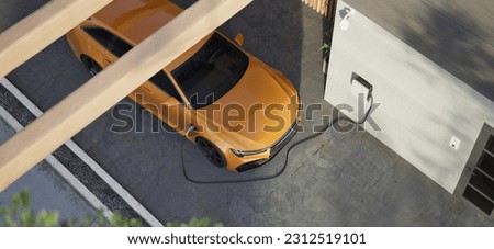 High angle Generic electric vehicle EV hybrid car is being charged from a wallbox on a contemporary modern residential building house