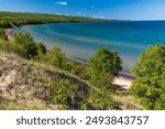 A high angle of Great Sand Bay of Lake Superior covered with greenery on Keweenaw peninsula, Michigan