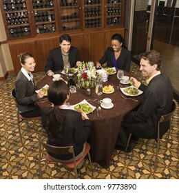 High angle of group of businesspeople in restaurant dining.