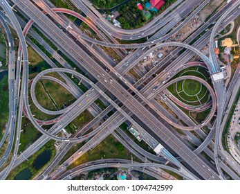 High angle looking top down view of complicate road and expressway intersection in Bangkok city of Thailand. Shot by drone can use for transportation or abstract concept.