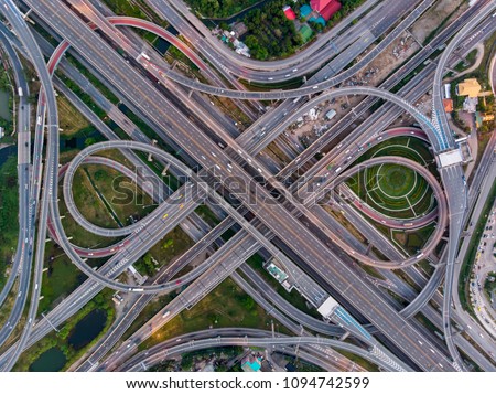High angle looking top down view of complicate road and expressway intersection in Bangkok city of Thailand. Shot by drone can use for transportation or abstract concept.