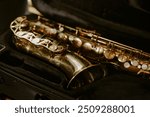 High angle medium closeup of saxophone in black colored case