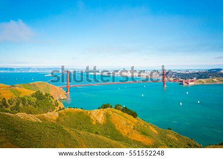High angle, mid-air, aerial view of downtown San Francisco city, bay seen together with Golden Gate Bridge and hills of Marin headlands on a summer day in California. Telephoto compressed