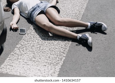 High Angle On Pedestrian Crossing And Smartphone Next To Victim Of Traffic Accident