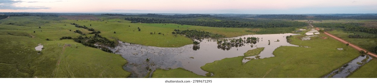 High angle panoramic view of fish farming infrastructure and lush cattle pastures near Apui along the Transamazon Highway BR-230 Brazil