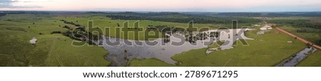High angle panoramic view of fish farming infrastructure and lush cattle pastures near Apui along the Transamazon Highway BR-230 Brazil