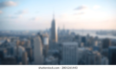 High angle panoramic view of Manhattan skyscrapers and the iconic Empire State Building during golden hour in New York