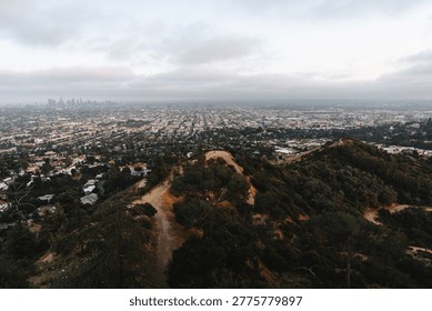 High angle panoramic view of sprawling city from mountain hiking trail