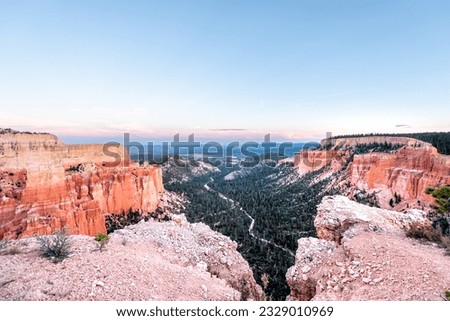 High angle paria point view overlook on orange colorful hoodoos red rock formations in Bryce Canyon National Park at colorful sunset with rocks