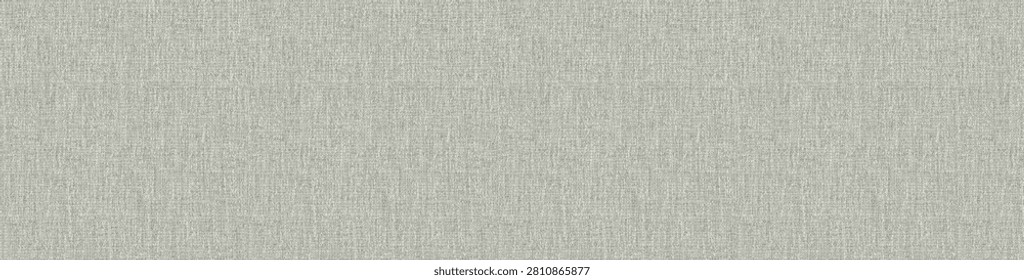 High angle perspective of a cool grey slub canvas textile with characteristic irregular yarn thicknesses and a natural organic weave.