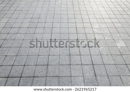 High angle perspective view background of empty grey square floor tiles pavement showing pattern texture.