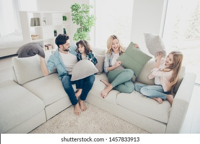 High angle photo of adopted family four members spend free time playing pillows sit couch living room - Shutterstock ID 1457833913
