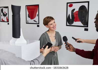 High Angle Portrait Of Elegant Tattooed Woman Giving Interview To Reporters While Opening Modern Art Gallery Exhibition