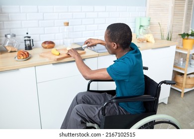 High Angle Portrait Of Independent Black Man With Disability Cooking Breakfast In Home Kitchen, Copy Space