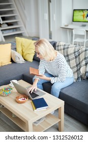 High Angle Portrait Of Modern Adult Woman Paying Bills Via Online Banking From Home, Copy Pace