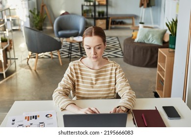 High Angle Portrait Of Young Caucasian Woman Using Laptop At Workplace In Office Setting, Copy Space