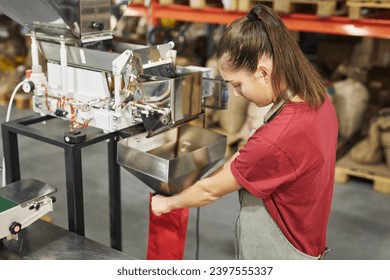 High angle portrait of young woman overseeing packaging process at small artisanal coffee production, copy space - Powered by Shutterstock