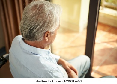 high angle rear view of a lonely asian old man sitting in wheel chair in nursing home - Powered by Shutterstock