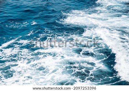 High angle of ship trail forming wave on surface of blue water of sea on Isla de Lobos. Abstract background of seawater