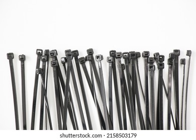 A high angle shot of black nylon cable ties isolated on white background