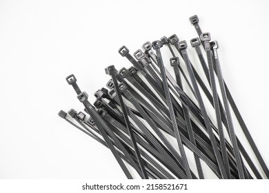 A high angle shot of black nylon cable ties isolated on white background