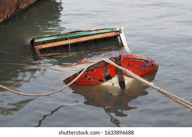 A High Angle Shot Of A Broken Sinking Sailboat In A River