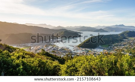 A high angle shot of the coastline town Picton with mountains and clear sky in the background
