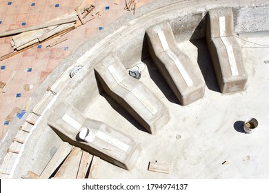 A high angle shot of an empty pool and tools for renovation