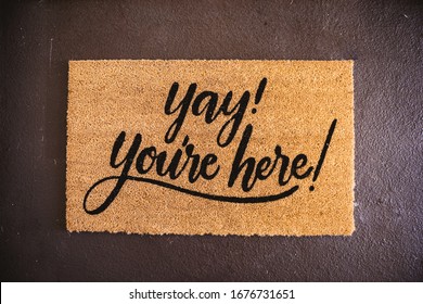 A high angle shot of a foot rug with a text "Yay! you're here!"