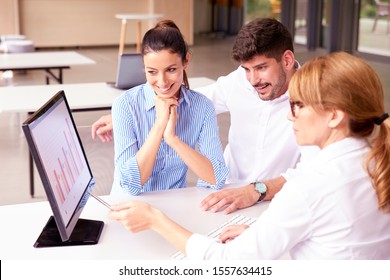 High angle shot of investment adviser  businesswoman giving a presentation to a friendly smiling young couple seated at her desk in the office.