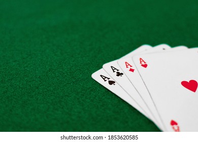 A High Angle Shot Of Playing Cards On A Green Table - Concept Of Poker