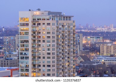 A High Angle Shot Of High Rise Apartment Buildings In Minneapolis Compressed Against The Distant St Paul Skyline During Twilight