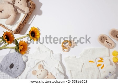 High angle shot at a set of stuff and accessories for newborn baby flat lay on white background. Baby template with copy space for adding text and designing