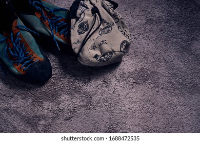 A High Angle Shot Of Sports Shoes And A Bag On A Concrete Ground